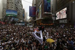 Protesters urging new leader Leung Chun-ying to step down crowd a street in Hong Kong